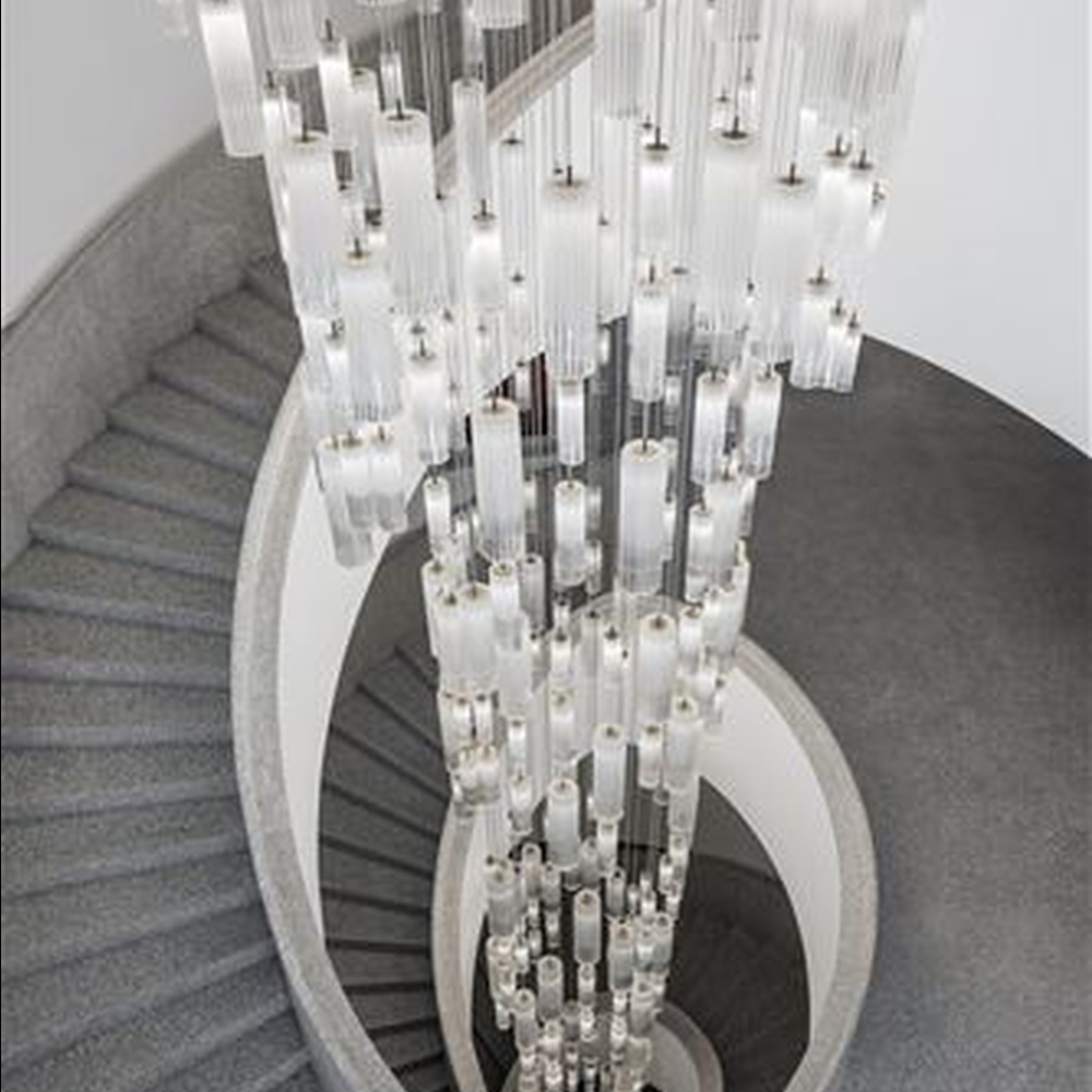This is a modern minimalist large waterfall-style pendant chandelier, composed of densely hung transparent and translucent crystal tubes, presenting a dynamic flowing water shape, with both decorative and lighting functions, ideal for high-ceiling public spaces such as hotel lobbies and shopping mall atriums.