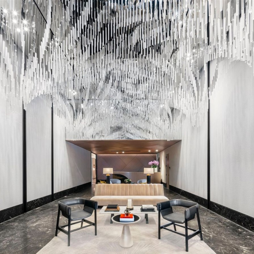 Modern Art Rain Curtain Crystal Chandelier, composed of numerous transparent crystal/acrylic strips suspended in a staggered arrangement, serves both lighting and decorative purposes, ideal for hotel lobbies, sales centers, high-end clubs and other high-ceiling public spaces.