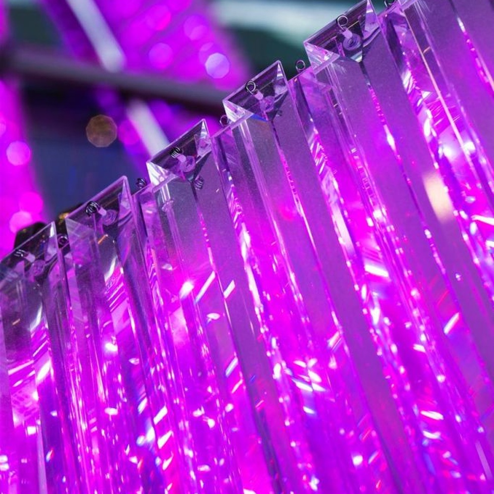 This is a large suspended art installation lamp, supported by a metal frame with blue-purple-cyan gradient LED light strips, featuring an abstract spiral and crescent shape, with both decorative and lighting functions, ideal as artistic decorative lighting for public spaces.