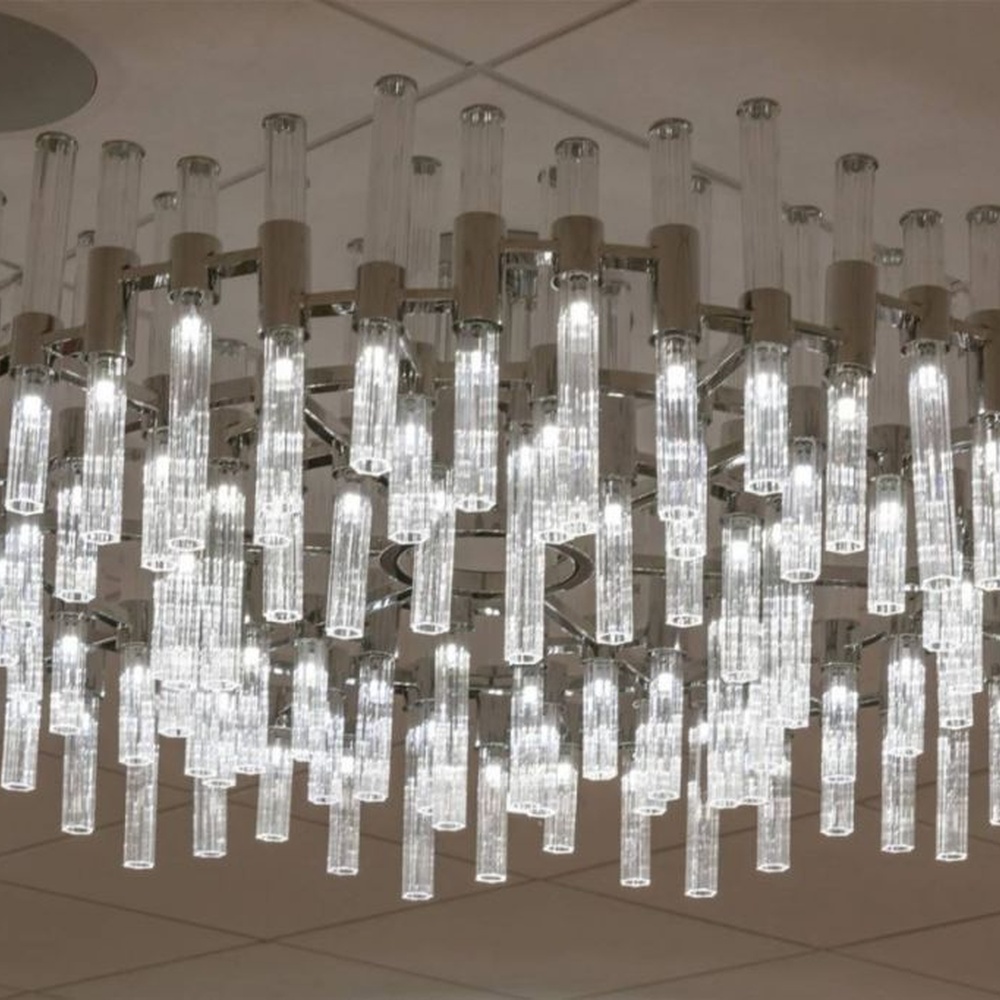 This modern light rain art lighting group consists of a large number of slender linear light strips hanging vertically, creating a "pouring light rain" visual effect with a wooden background wall, serving both lighting and installation art purposes, suitable for high-ceiling commercial spaces such as hotel lobbies and convention centers.