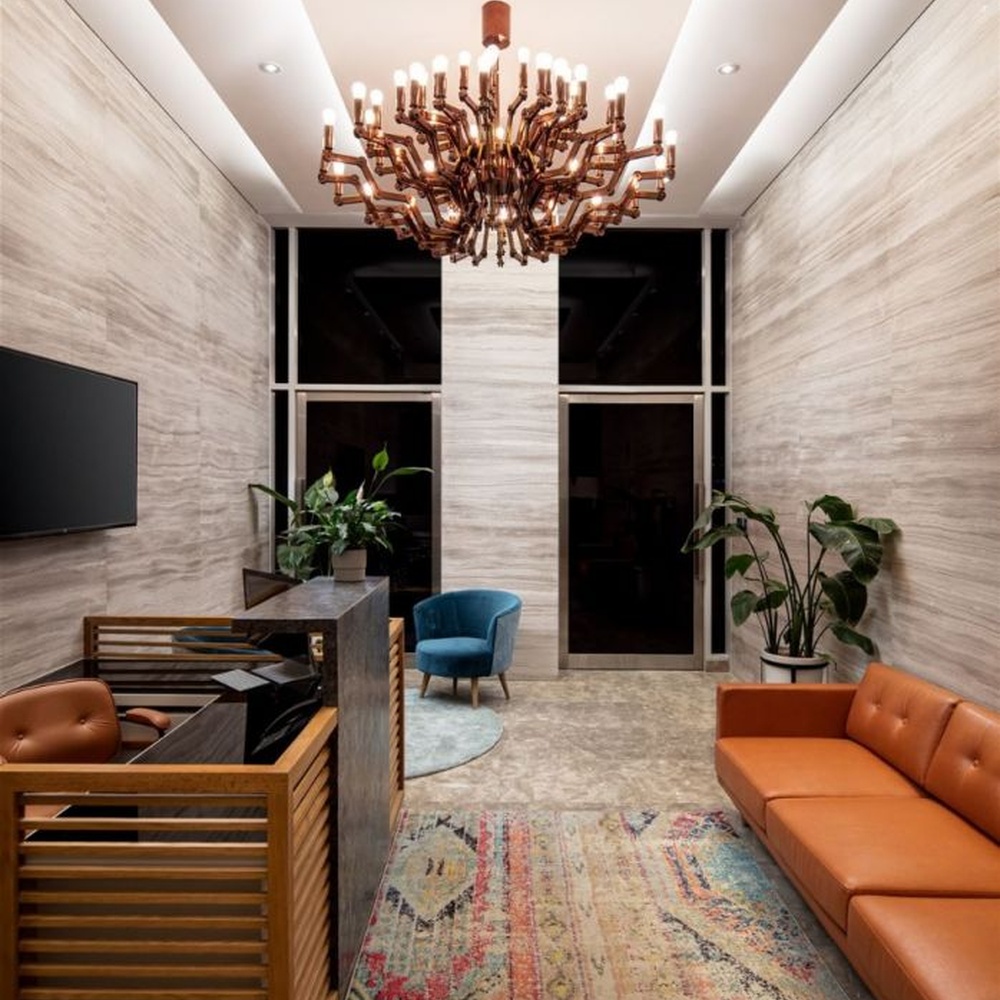 This branch-shaped multi-head chandelier features a fork-shaped lamp frame made of wood-like material, paired with multiple groups of staggered light-emitting lamp heads, presenting a visual effect that combines natural artistry and modern industrial style, suitable for core lighting and decoration in high-ceiling public spaces.