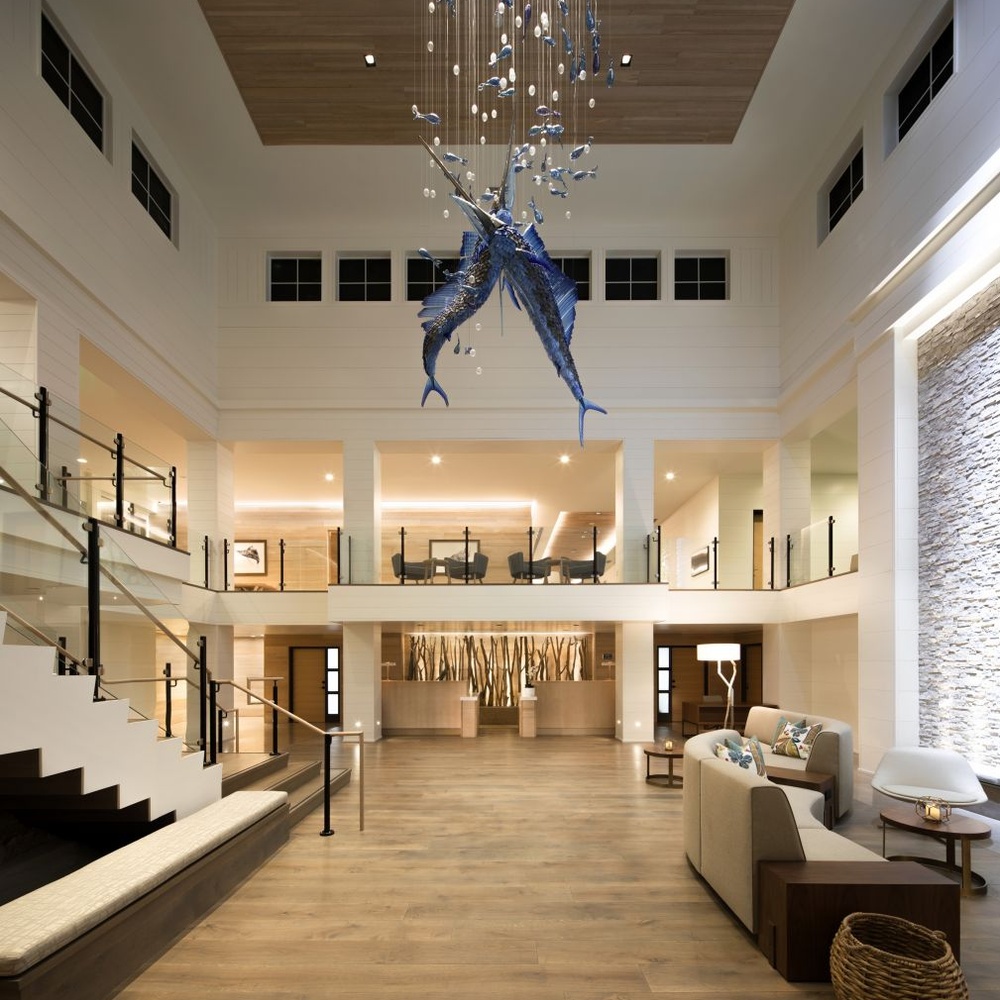 This ocean-themed art chandelier features swordfish shapes made of blue liuli, paired with bubble decorations, presenting a dynamic deep-sea swimming effect, serving both lighting and decorative purposes, suitable for coastal hotels, seafood restaurants and other spaces.