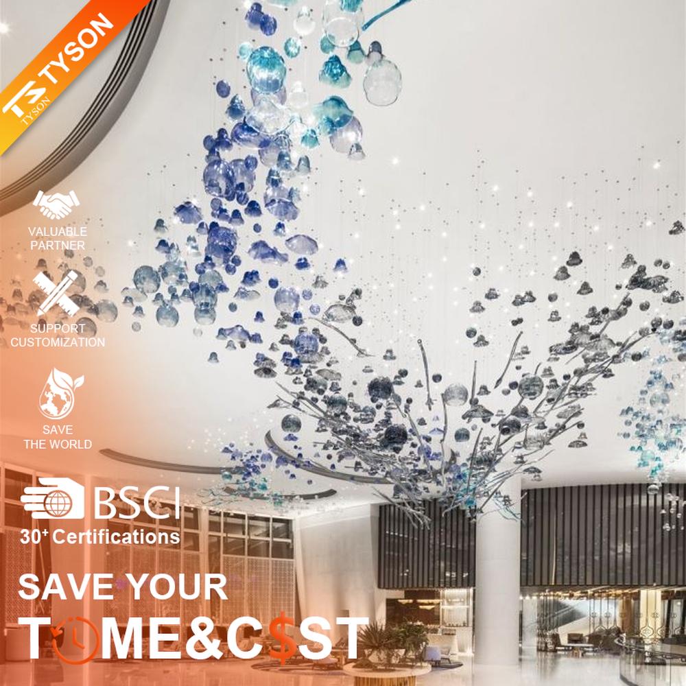 This blue-tone liuli bubble art chandelier is composed of gradient blue and transparent glass bubbles intertwined with metal lines, presenting a dynamic shape like marine plankton. Light refracts through the liuli to emit a transparent and soft halo, serving both lighting and installation art purposes, suitable for high-end commercial spaces such as hotel lobbies and art exhibition halls.