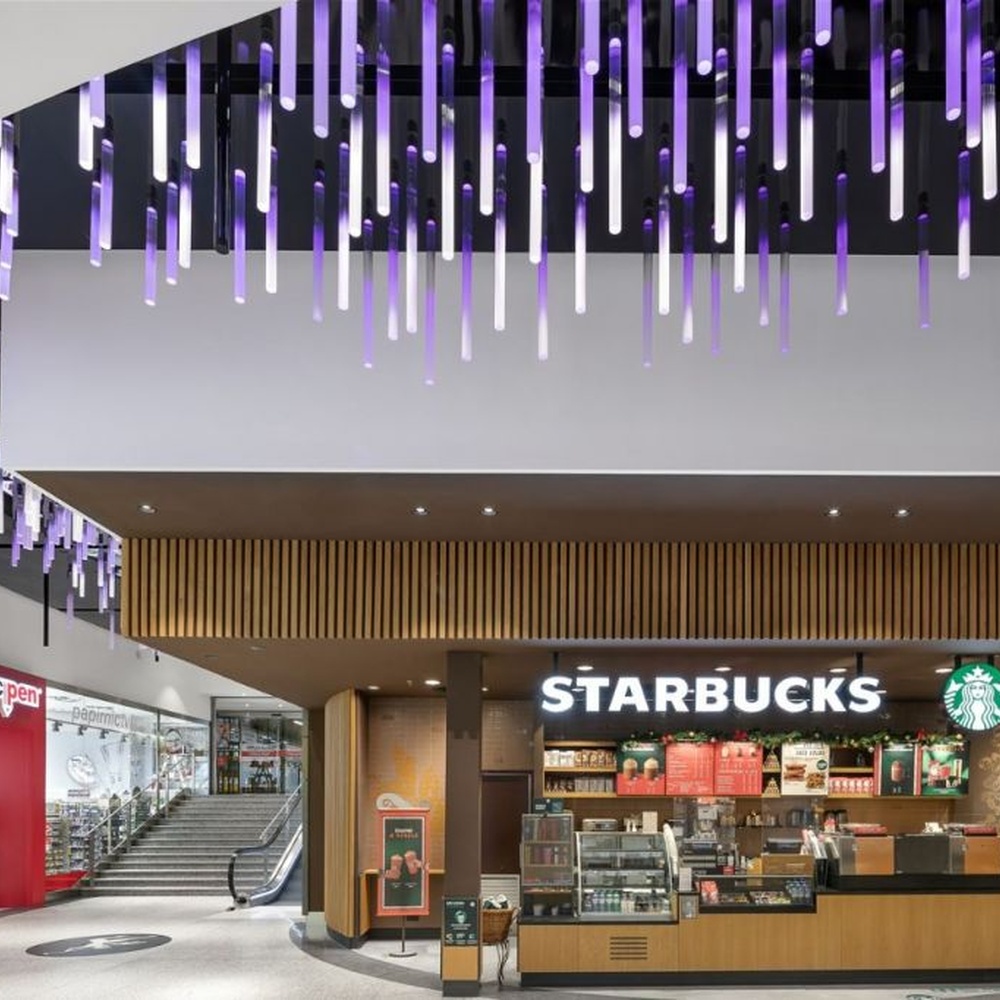 This is an immersive LED pendant light array, composed of densely arranged purple gradient LED light strips arranged vertically, presenting a flowing starry sky effect, with both decorative and atmosphere-creating functions, ideal for trendy commercial spaces such as brand stores and commercial entrances.
