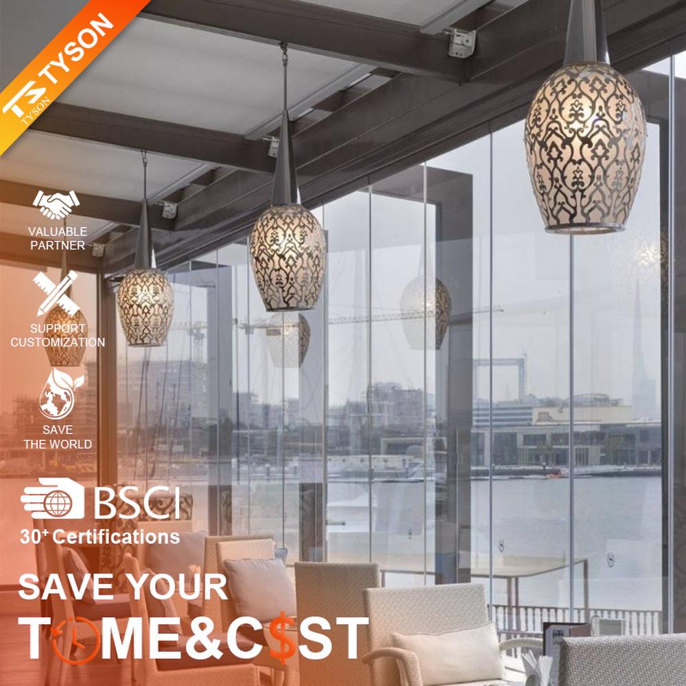 This light luxury black-gold hollow egg-shaped chandelier features retro scroll patterns carved from metal, with warm light refracting delicate shadows through the hollow texture, serving both lighting and decorative purposes, suitable for light luxury spaces such as restaurants and hotel corridors.