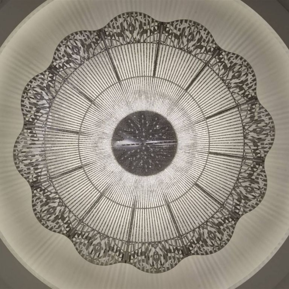 This large petal-shaped crystal ceiling lamp consists of radial crystal strips forming a hollow petal shape, with light refracting a brilliant halo through it, serving both lighting and decorative purposes, suitable for high-end luxury spaces such as hotel banquet halls and large clubs.