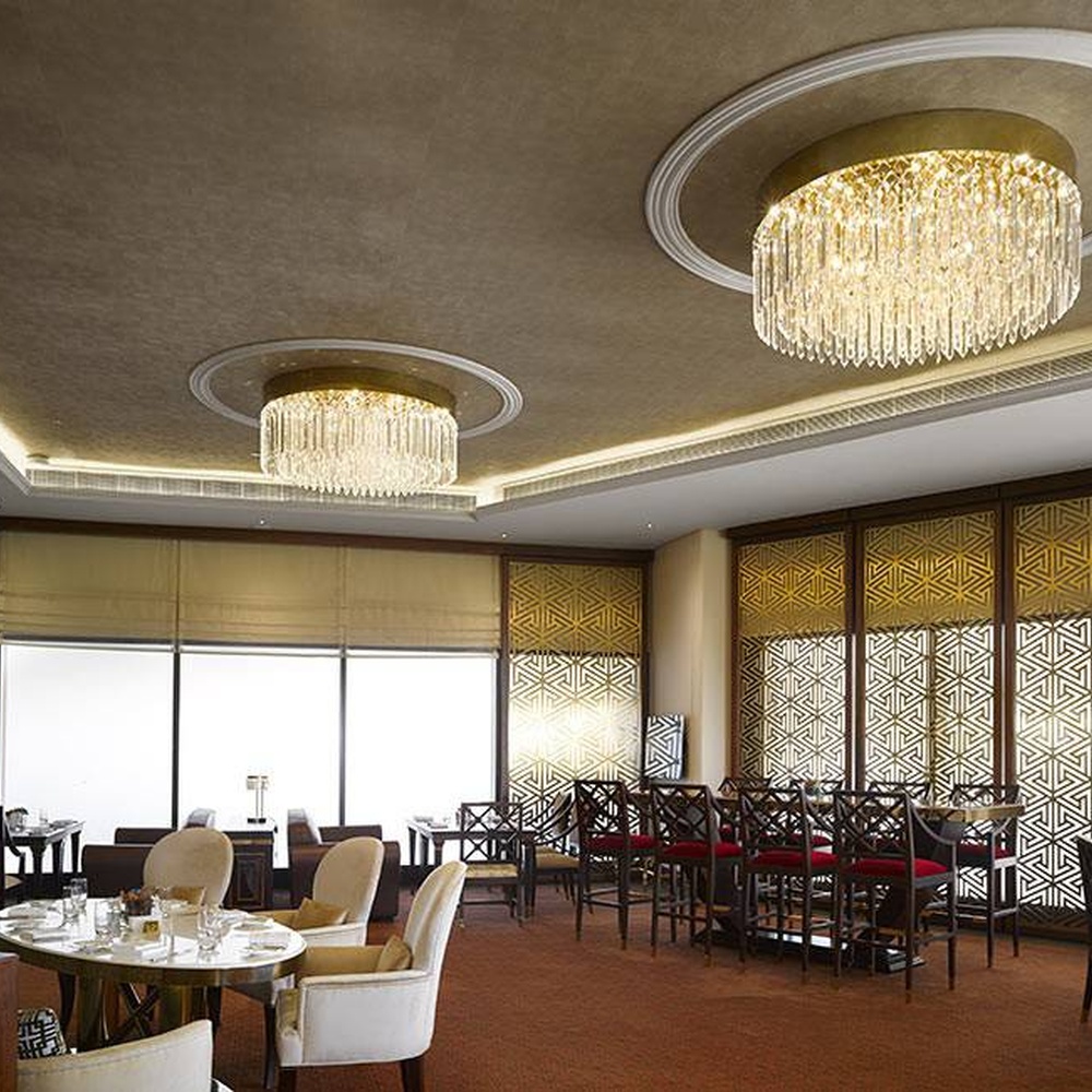 This light luxury round tassel crystal ceiling lamp features a circular drooping shape made of a metal frame and multi-layer faceted crystal strips, with light refracting a brilliant halo through the crystals, serving both lighting and decorative purposes, suitable for high-end luxury spaces such as hotel lobbies and clubs.