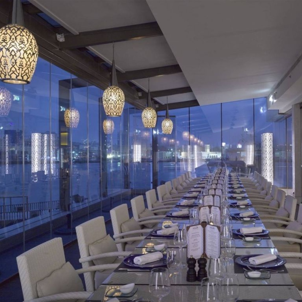 This light luxury black-gold hollow egg-shaped chandelier features retro scroll patterns carved from metal, with warm light refracting delicate shadows through the hollow texture, serving both lighting and decorative purposes, suitable for light luxury spaces such as restaurants and hotel corridors.