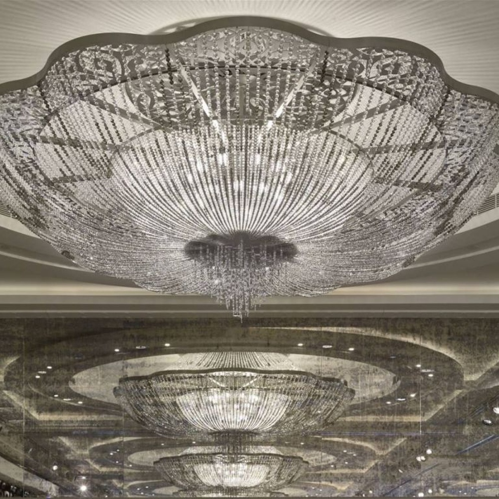 This large petal-shaped crystal ceiling lamp consists of radial crystal strips forming a hollow petal shape, with light refracting a brilliant halo through it, serving both lighting and decorative purposes, suitable for high-end luxury spaces such as hotel banquet halls and large clubs.