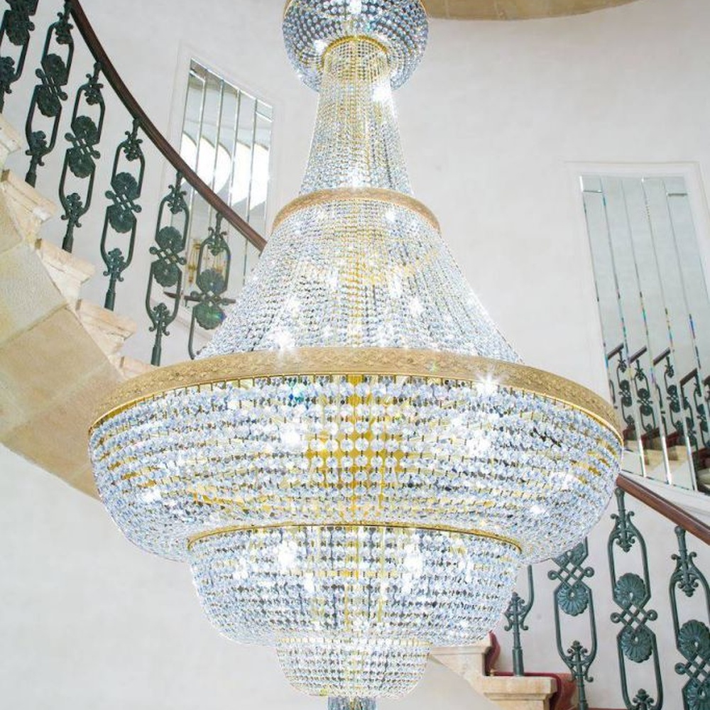 This European court-style golden goblet vase multi-layer crystal chandelier features a gold metal frame paired with dense high-transparency crystals, forming a multi-layer tower structure in the shape of a vase, with brilliant and luxurious light, serving both lighting and decorative purposes, suitable for high-end high-ceiling spaces such as villa high-ceiling staircases and hotel lobbies.