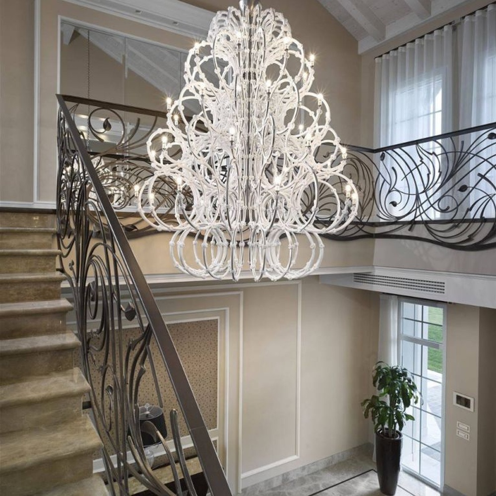 This large white crystal corolla art chandelier is handcrafted with high-transparency glass/crystal into a layered, curled ring structure, forming a blooming corolla shape, with brilliant and soft light, serving both lighting and decorative purposes, suitable for high-end high-ceiling spaces such as villa high-ceiling living rooms and hotel lobbies.