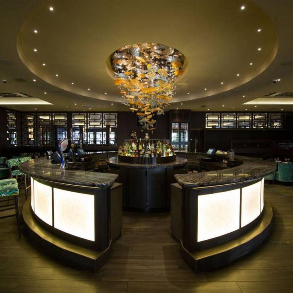 Modern artistic waterfall-style gradient glass chandelier, with gold-brown gradient glass particles creating an irregular cloud hanging shape, combining decorative and main lighting functions, suitable for high-end restaurants, clubs, hotel bars and other light luxury style spaces.
