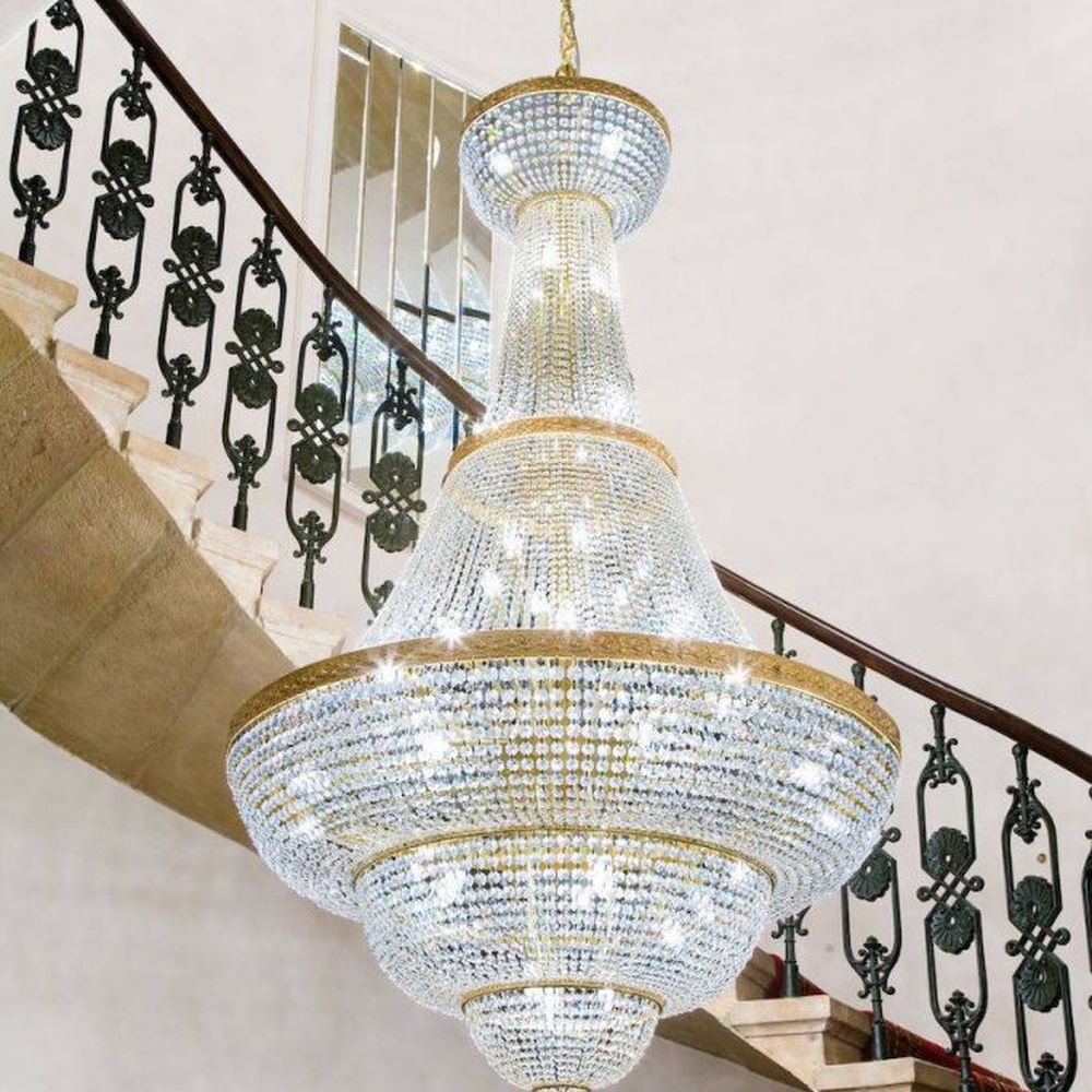 This European court-style golden goblet vase multi-layer crystal chandelier features a gold metal frame paired with dense high-transparency crystals, forming a multi-layer tower structure in the shape of a vase, with brilliant and luxurious light, serving both lighting and decorative purposes, suitable for high-end high-ceiling spaces such as villa high-ceiling staircases and hotel lobbies.