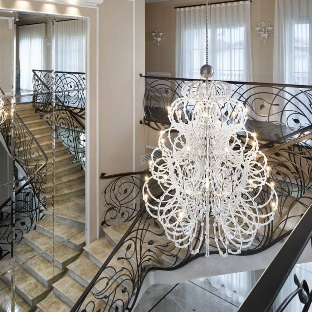 This large white crystal corolla art chandelier is handcrafted with high-transparency glass/crystal into a layered, curled ring structure, forming a blooming corolla shape, with brilliant and soft light, serving both lighting and decorative purposes, suitable for high-end high-ceiling spaces such as villa high-ceiling living rooms and hotel lobbies.