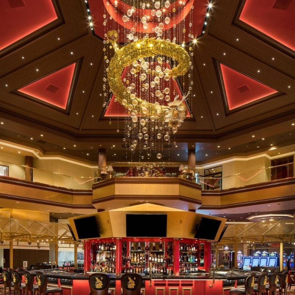 This large multi-layer ring crystal chandelier features a red-gold contrasting metal frame paired with dense crystal beads and gold ring decorations, with dazzling light, serving both lighting and decorative purposes, suitable for luxury commercial spaces such as casinos and high-end clubs.