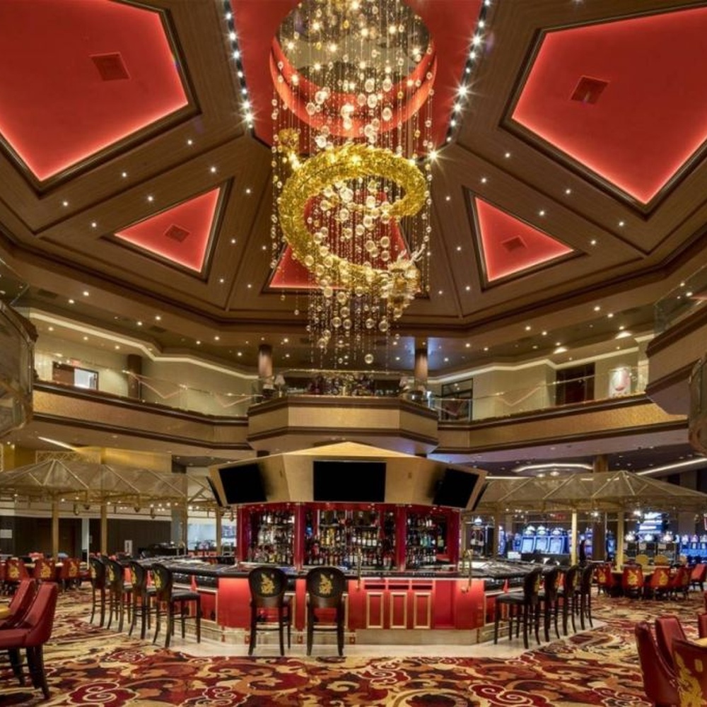 This large multi-layer ring crystal chandelier features a red-gold contrasting metal frame paired with dense crystal beads and gold ring decorations, with dazzling light, serving both lighting and decorative purposes, suitable for luxury commercial spaces such as casinos and high-end clubs.