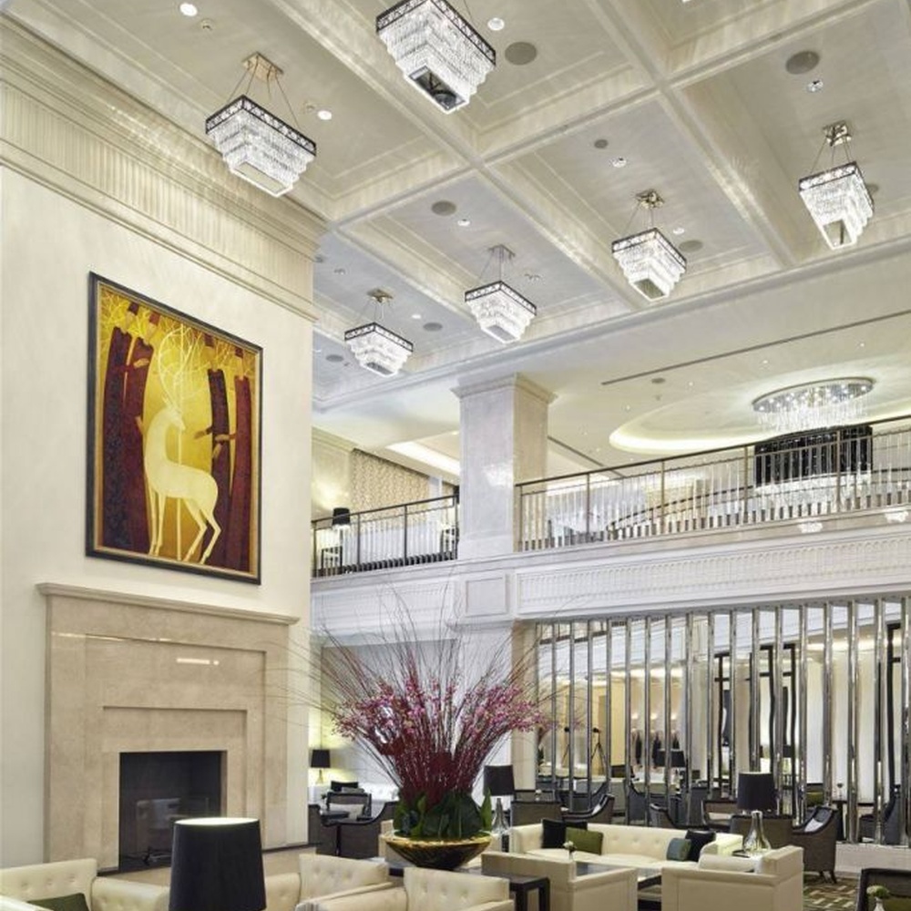 Modern light luxury rectangular multi-layer crystal chandelier, with a black-framed metal frame and layered transparent crystal strips, featuring bright and soft light, combining decorative and lighting functions, suitable for hotel lobbies, high-end clubs, commercial atriums and other high-ceiling commercial spaces.