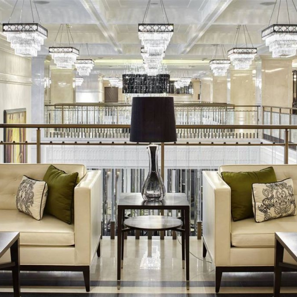 Modern light luxury rectangular multi-layer crystal chandelier, with a black-framed metal frame and layered transparent crystal strips, featuring bright and soft light, combining decorative and lighting functions, suitable for hotel lobbies, high-end clubs, commercial atriums and other high-ceiling commercial spaces.