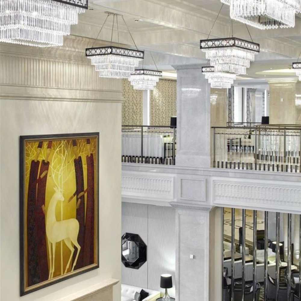 Modern light luxury rectangular multi-layer crystal chandelier, with a black-framed metal frame and layered transparent crystal strips, featuring bright and soft light, combining decorative and lighting functions, suitable for hotel lobbies, high-end clubs, commercial atriums and other high-ceiling commercial spaces.