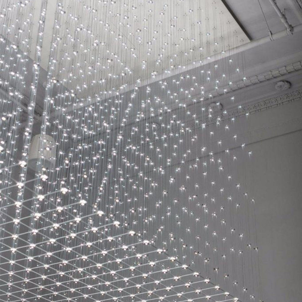 Modern artistic matrix-style hanging crystal lamp group, composed of dense crystal particles/LED beads suspended by thin wires to form a transparent light curtain, combining decorative and ambient lighting functions, suitable for high-ceiling spaces such as hotel lobbies, commercial atriums, and art exhibition halls.