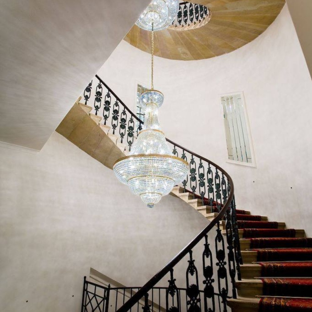 This European court-style golden goblet vase multi-layer crystal chandelier features a gold metal frame paired with dense high-transparency crystals, forming a multi-layer tower structure in the shape of a vase, with brilliant and luxurious light, serving both lighting and decorative purposes, suitable for high-end high-ceiling spaces such as villa high-ceiling staircases and hotel lobbies.