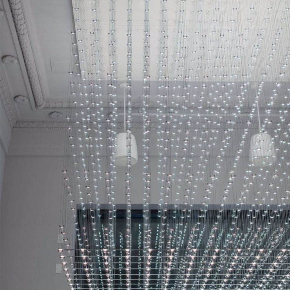 Modern artistic matrix-style hanging crystal lamp group, composed of dense crystal particles/LED beads suspended by thin wires to form a transparent light curtain, combining decorative and ambient lighting functions, suitable for high-ceiling spaces such as hotel lobbies, commercial atriums, and art exhibition halls.
