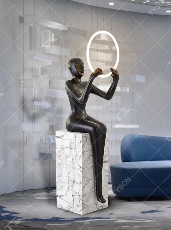 This is an artistic sculpture floor lamp, featuring a black human sculpture holding a circular luminous lamp, with a marble base. It is highly artistic and creative in design. It is used for space lighting and artistic decoration, significantly enhancing the artistic atmosphere and style of the space. It is suitable for modern art - style homes, high - end hotel lobbies, art exhibition halls, luxury clubs and other places.