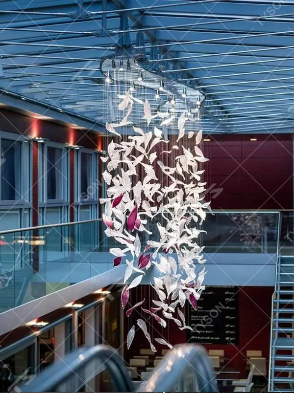 This is a modern artistic bird-shaped chandelier, composed of numerous white and pink bird-like elements hanging together. It features a highly artistic and visually striking design, with a dynamic beauty like a flock of birds flying. It is used for space lighting and artistic decoration, capable of creating a creative visual focus and enhancing the artistic atmosphere of the space. It is suitable for atriums of high-end commercial centers, modern art galleries, lobbies of luxury hotels and other places.