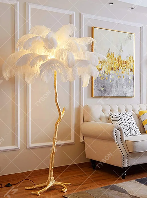 This is a luxury artistic floor lamp with a golden branch - shaped stand and a pink ostrich feather lampshade, featuring a romantic and luxurious design that shows elegant texture under warm light. It is used for space lighting and artistic decoration, combining practicality and aesthetics. It is suitable for modern luxury home living rooms, bedrooms, high - end hotel leisure areas, wedding photography scenes and other places.