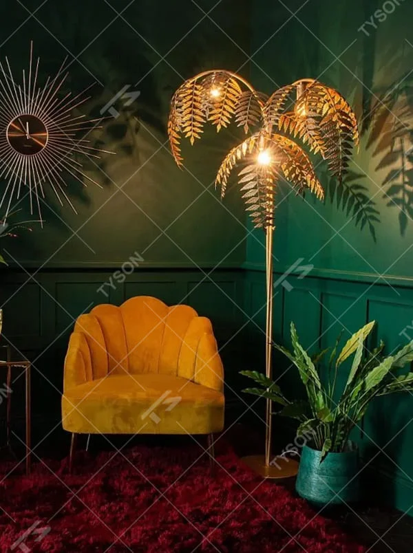 This is a tropical artistic floor lamp with golden palm leaf-shaped lamp heads and a metal pole, featuring a strong tropical artistic sense. It is used for space lighting and decoration, creating a tropical artistic atmosphere. It is suitable for tropical-style home living rooms, creative cafes, art homestays and other places.