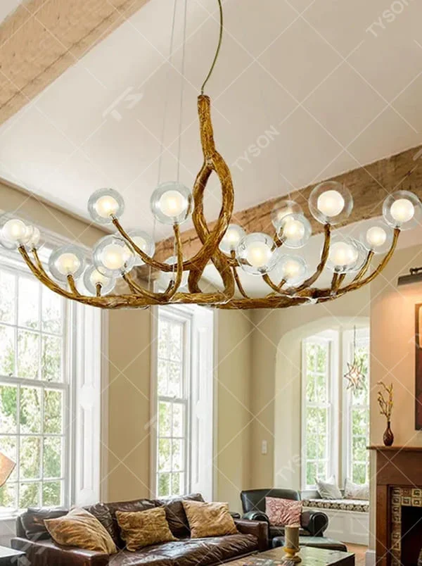 This is a luxury natural-style branch-shaped chandelier with golden metal branch-like brackets and multiple transparent spherical lampshades. It features a highly artistic design with a natural luxury ambiance. It is used for space lighting and decoration, creating a natural artistic visual focus. It is suitable for luxury-style home living rooms, art villa spaces, high-end music rooms and other places.