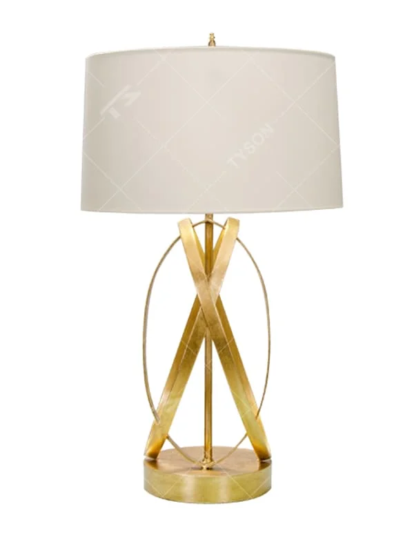 This is a luxury-style table lamp with golden crossed metal brackets and a beige fabric lampshade. It features a simple and elegant design with excellent texture. It is used for local desktop lighting and decoration, creating a luxurious and warm ambiance. It is suitable for luxury-style home bedroom bedside tables, high-end hotel guest rooms, modern office spaces and other places.