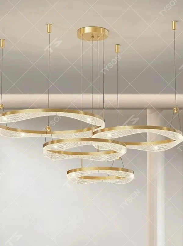 This is a modern luxury multi-layer circular chandelier, with golden metal circular frames hanging in a scattered manner, featuring artistic layers and strong luxury sense. It is used for space lighting and decoration, creating a high-end artistic atmosphere. It is suitable for high-ceilinged living rooms, high-end hotel lobbies, modern art exhibition halls and other places.