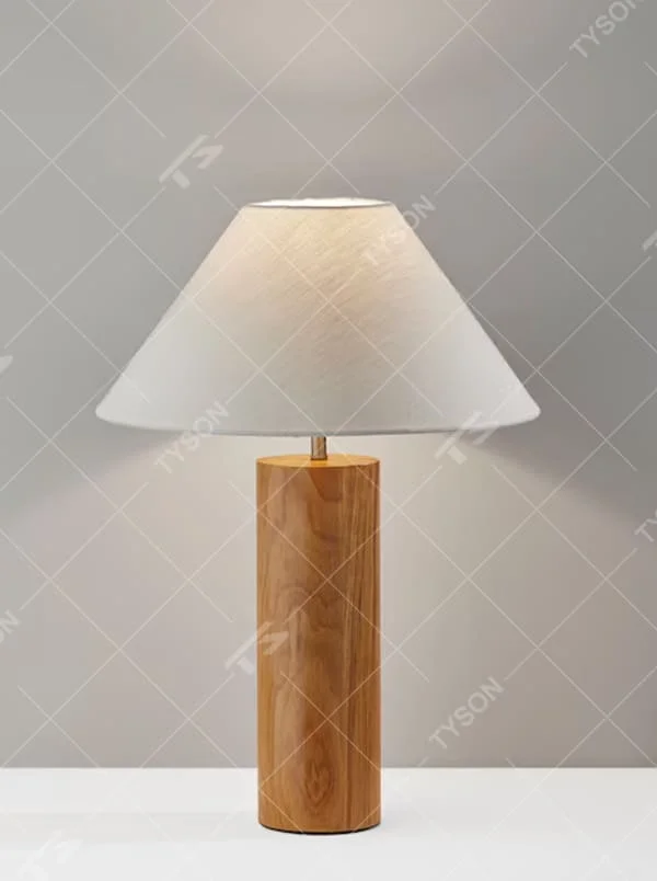 This is a natural minimalist wooden table lamp with a cylindrical solid wood base and a white fabric slant lampshade. It features a rustic and natural design with a warm ambiance. It is used for local desktop lighting and decoration, creating a natural and warm atmosphere. It is suitable for Nordic-style home bedrooms, Japanese art homestays, literary cafes and other places.