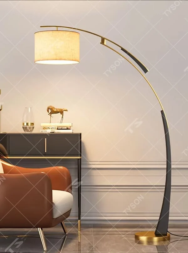 This is a modern luxury arc floor lamp, with a black-gold arc metal stand, a beige fabric cylindrical lampshade, and a golden base, featuring a minimalist and grand design with strong luxury texture. It is used for space lighting and decoration, creating a warm luxury atmosphere. It is suitable for modern luxury home living rooms, leisure reading areas, high-end hotel guest rooms and other places.