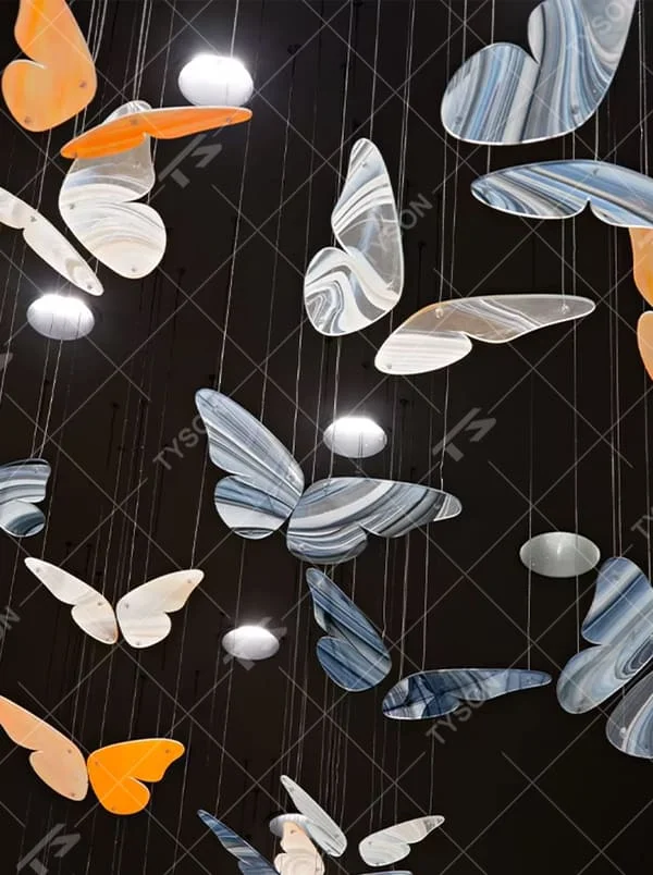 This is an artistic and childlike colorful butterfly-shaped chandelier, with butterfly leaves in various colors (orange, white, blue-gray, etc.) hanging in a scattered manner, featuring strong artistic sense and childlike charm, like a group of butterflies dancing under the light. It is used for space lighting and artistic decoration, creating a lively and artistic atmosphere. Suitable for children's parks, theme restaurants, art exhibition halls and other places.