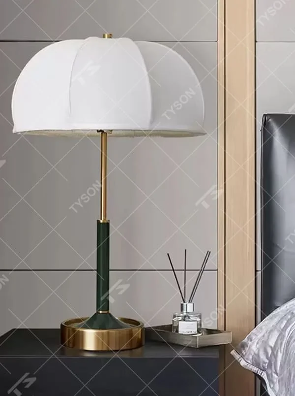 This is a light luxury retro umbrella - shaped fabric table lamp, with a white umbrella - shaped fabric lampshade paired with golden and dark green metal stands, and a golden base. It features a minimalist retro and light luxury elegant design, with warm and soft lighting. It is used for local desktop lighting and decoration, creating a light luxury retro atmosphere. Suitable for light luxury - style bedroom bedside tables, modern retro - style living room side tables, high - end hotel guest rooms and other places.