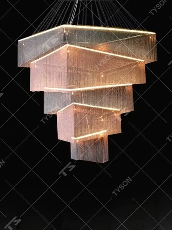 This is a modern artistic multi-layer square metal chain chandelier, composed of multi-layer square structures, paired with metal chains and LED light strips. It features soft and layered lighting, with a strong sense of modernity and spatial tension. It is used for space lighting and artistic decoration, creating a modern artistic and high-end atmosphere. Suitable for high-end hotel lobbies, art exhibition halls, high-ceiling spaces in luxury villas and other places.