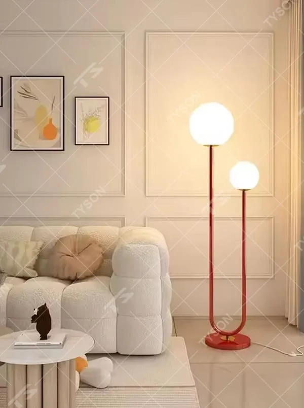 This is a modern vibrant red U-shaped double-sphere floor lamp, with a red U-shaped metal pole and two white spherical lampshades, featuring a minimalist and lively design, modern style. It is used for space lighting and decoration, creating a warm and vibrant atmosphere. Suitable for modern minimalist living rooms, children's rooms, creative studios and other places.