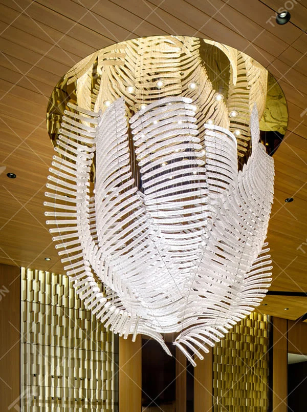 This is an artistic installation-style white leaf-shaped chandelier, with numerous white leaf-shaped elements (similar to feathers or fern leaves) hanging in a scattered manner by thin wires to form a three-dimensional layer. It features soft lighting and a strong sense of modern art and spatial tension. It is used for space lighting and artistic decoration, creating a modern artistic and ethereal atmosphere. Suitable for high-end hotel lobbies, art exhibition halls, high-ceiling spaces in luxury villas and other places.