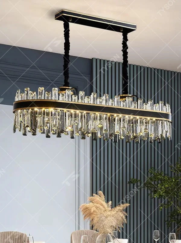 This is a light luxury modern-style black and gold rectangular crystal chandelier, with a black and gold metal frame, paired with numerous transparent crystal columns and black woven hanging ropes. It features a light luxury and grand design, with brilliant lighting. It is used for space lighting and decoration, creating a light luxury and high-end atmosphere. Suitable for light luxury-style restaurants, modern minimalist living rooms, high-end hotel dining areas and other places.