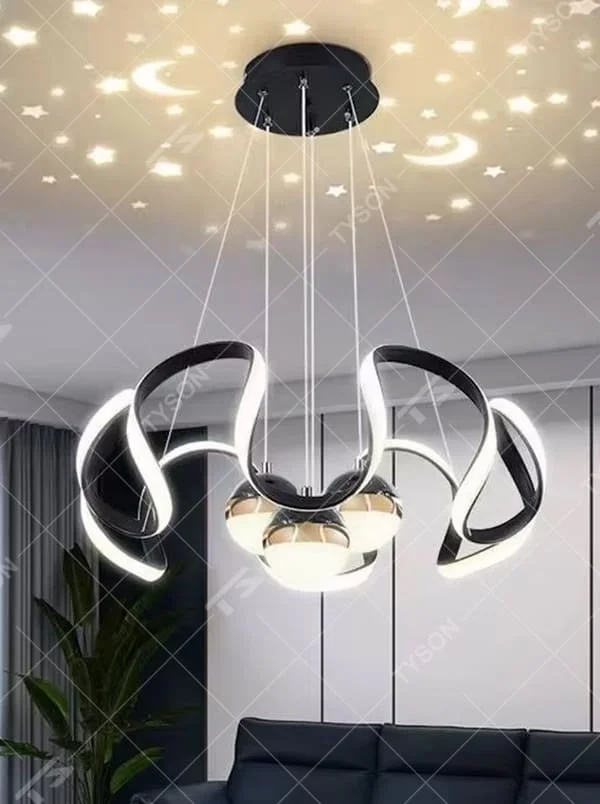 This is a childlike artistic golden starry sky projection chandelier, with golden curved light strips and starry sky decorated spherical lamps, which can project star and moon patterns onto the ceiling. The design is childlike and dreamy, with warm lighting. It is used for space lighting and atmosphere creation, suitable for children's rooms, modern-style bedrooms, childlike theme living rooms and other places.