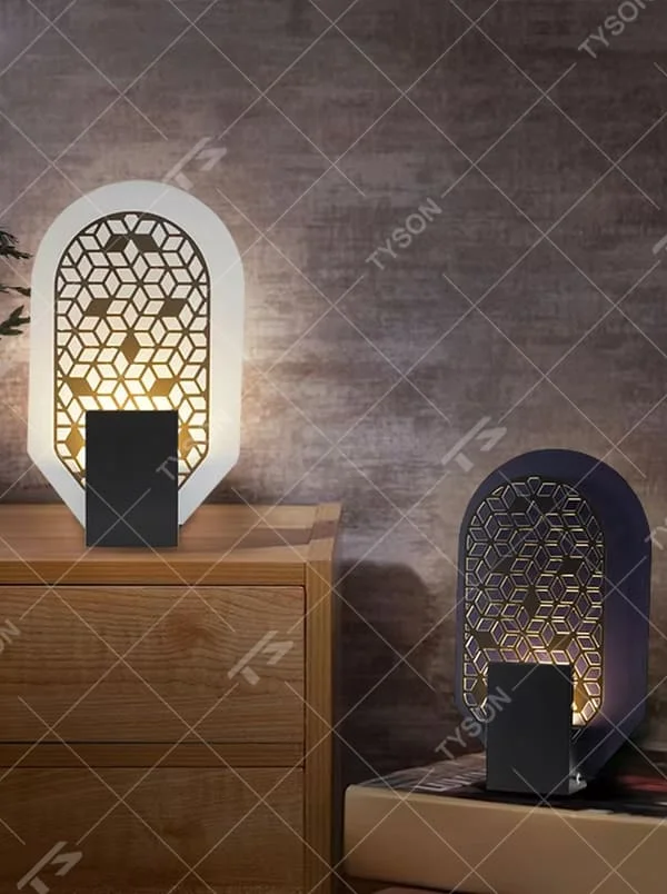 This is an artistic geometric hollow arch table lamp, with an arched hollow design (hexagonal geometric pattern), available in styles like white and orange, paired with different material bases. It features strong artistic sense, and the light forms unique light and shadow through the hollow. It is used for local desktop lighting and decoration, creating an artistic and warm atmosphere. Suitable for art exhibition halls, corners of modern home studies, designer studios and other places.