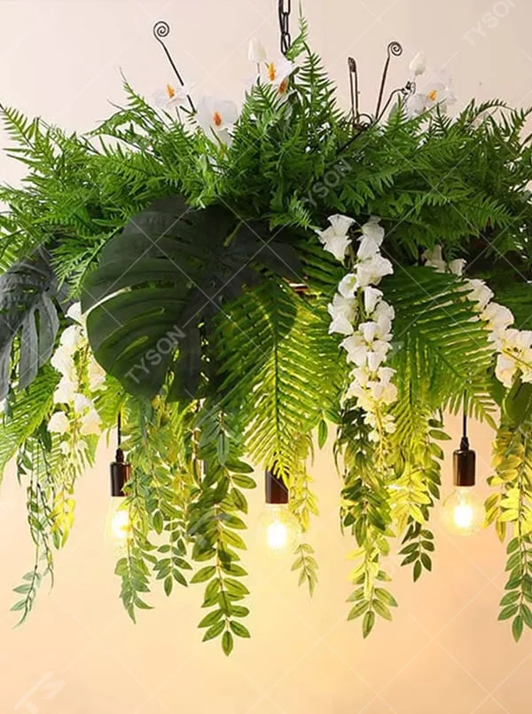 This is a natural and romantic floral retro chandelier, decorated with a large number of artificial flowers (pink and purple roses, etc.) and green plants (ferns, monstera leaves), paired with retro bulbs and a black metal frame. The design is natural and warm, with soft warm yellow lighting. It is used for space lighting and decoration, creating a natural romantic and warm retro atmosphere. Suitable for wedding venues, literary cafes, Nordic-style homestays, nature-themed restaurants and other places.
