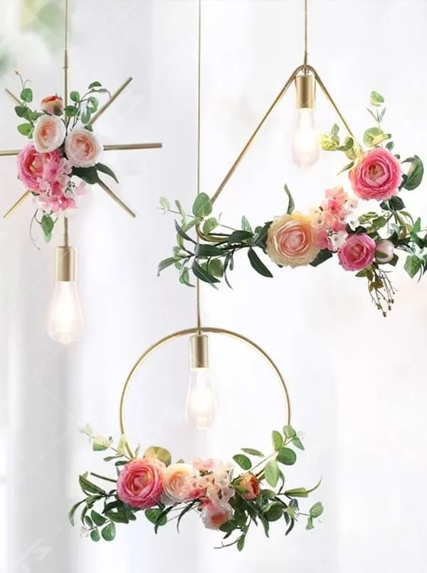 This is a natural and fresh floral metal chandelier, including two styles of golden circular and radial metal frames, paired with artificial green plants, flowers and transparent bulbs. It features a natural and romantic design with warm and soft lighting. It is used for space lighting and decoration, creating a natural and romantic atmosphere. Suitable for Nordic-style homes, literary cafes, wedding venues, art homestays and other places.