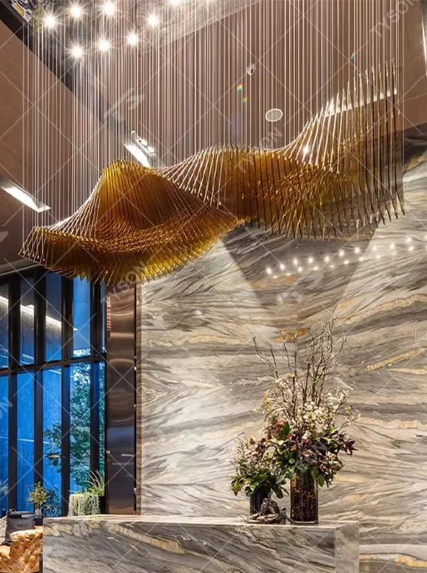 This is a modern artistic large wave-shaped metal art chandelier, with golden metal strips forming a three-dimensional wave shape, suspended by multiple thin wires. It features strong artistic tension and spatial decorativeness, with brilliant and grand lighting. It is used for space lighting and artistic installation decoration, creating a high-end artistic and luxurious atmosphere. Suitable for high-end hotel lobbies, luxury commercial clubs, art exhibition halls and other places.