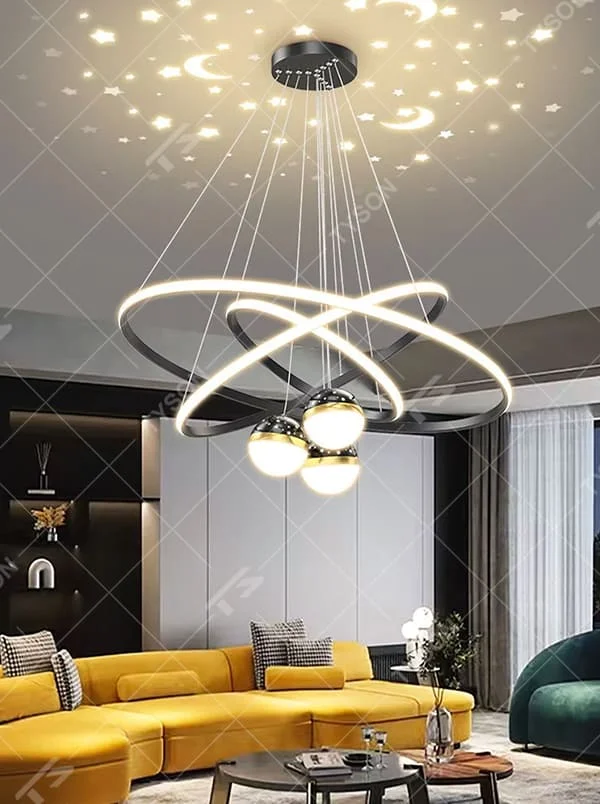 This is a modern creative cross-ring starry sky projection chandelier, with a black frame paired with cross-ring light strips and spherical lamps, and a starry sky (star and moon) projection function. The design is modern and dreamy, with soft lighting and a strong atmosphere. It is used for space lighting and atmosphere creation, suitable for modern-style living rooms, children's rooms, light luxury-style bedrooms and other places.