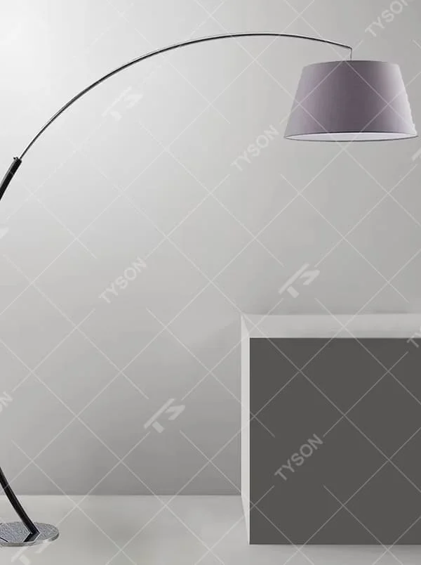 This is a modern minimalist curved floor lamp, with a black curved lamp pole paired with a light purple fabric lampshade and a silver textured disc base. The lighting is soft and warm, creating a minimalist comfortable atmosphere.