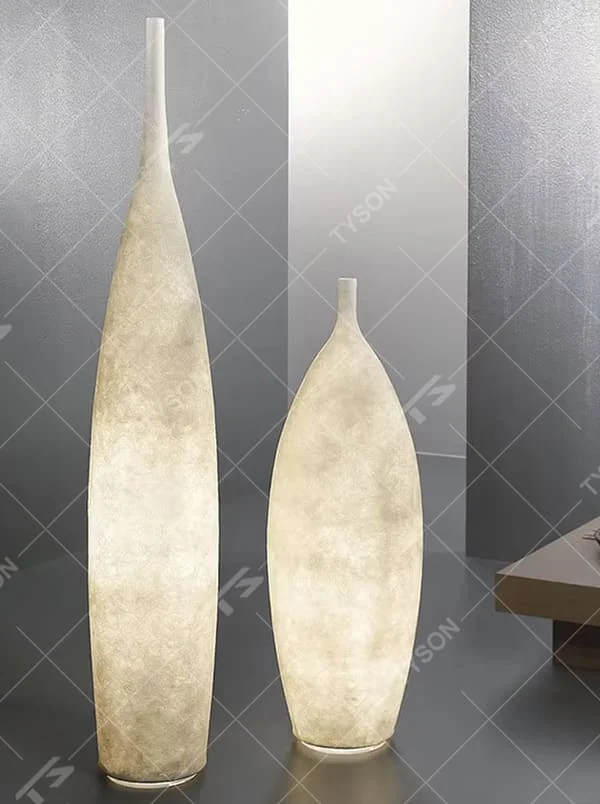 This is a Zen minimalist bottle-shaped paper art floor lamp (including large and small styles), made of light beige paper art texture material to create a slender bottle shape, with a large and small combination design. The light through the material is soft and hazy, creating a quiet and elegant atmosphere. It is used for space lighting and decoration, suitable for Zen-style spaces, minimalist homes and other places.