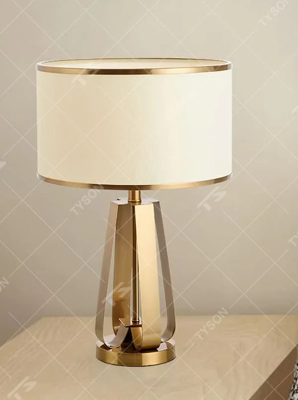 Light luxury golden geometric stand table lamp, beige fabric lampshade + golden decorative ring, soft lighting, creating a high-end elegant atmosphere.